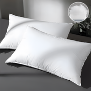Two white pillows on a dark surface with a close-up inset showing pillow filling.