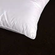 White pillow on a dark surface